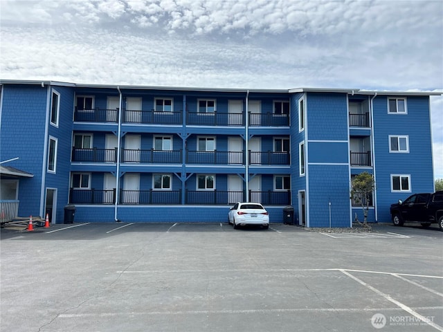 835 Ocean Shores Blvd NW Unit 208, Ocean Shores, WA 98569 - view of apartment building / complex featuring uncovered parking