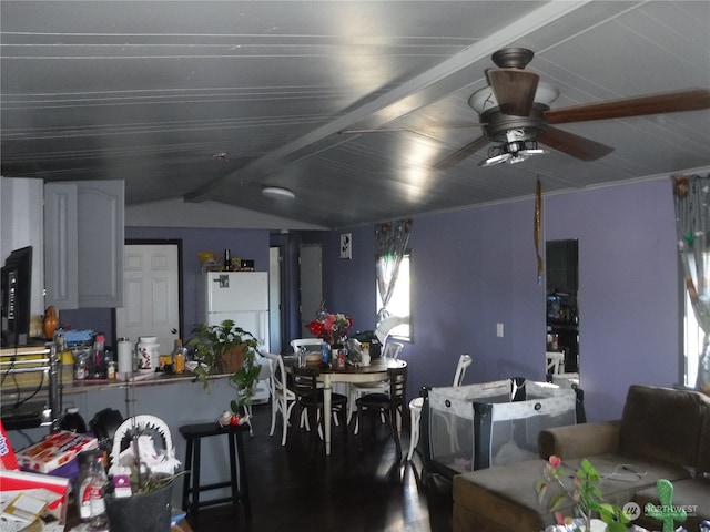 dining space featuring ceiling fan and vaulted ceiling with beams