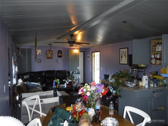 dining area with ceiling fan and beamed ceiling