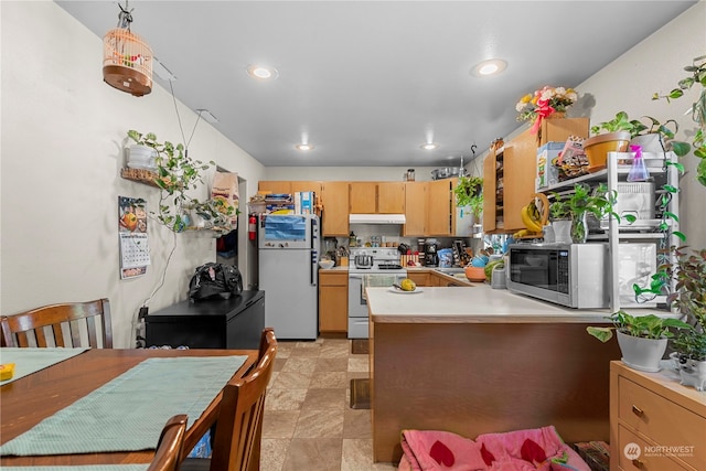 59 N Iowa Ave, East Wenatchee, WA 98802 - kitchen featuring kitchen peninsula, light tile flooring, white appliances, light brown cabinets, and pendant lighting