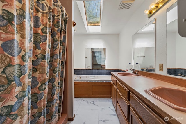 bathroom featuring tile floors, dual vanity, and a skylight