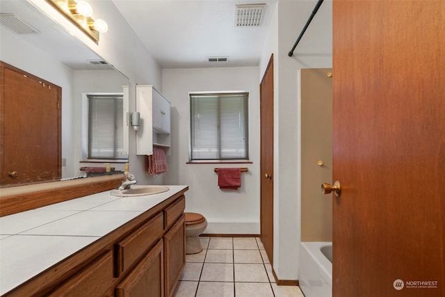 full bathroom featuring tub / shower combination, tile floors, toilet, and vanity with extensive cabinet space