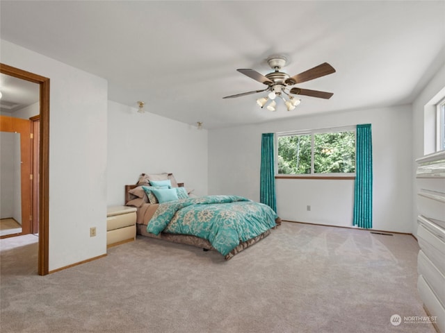 bedroom with ceiling fan and light colored carpet