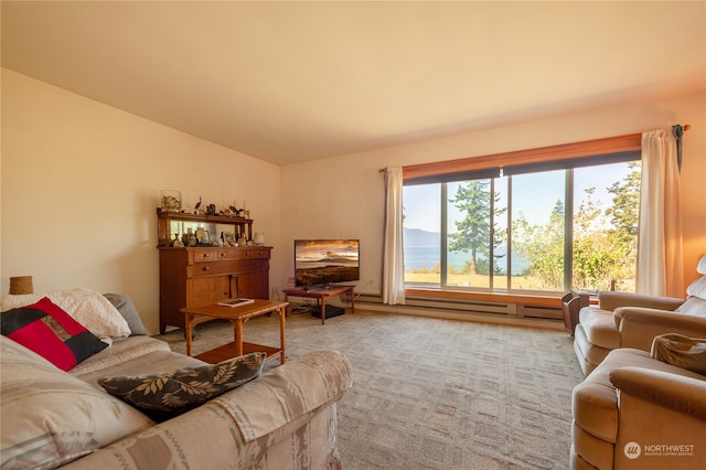 carpeted living room with a baseboard radiator and vaulted ceiling