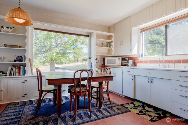 tiled dining space featuring sink