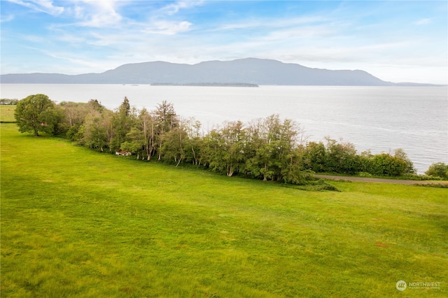 exterior space with a water and mountain view