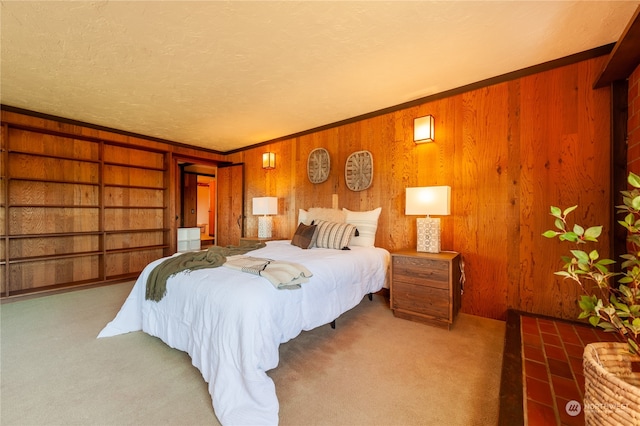 bedroom with crown molding, a textured ceiling, and carpet