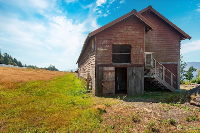 exterior space featuring a lawn and a rural view