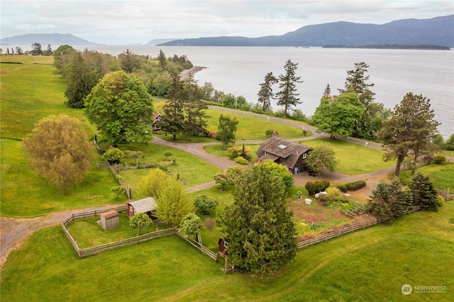 birds eye view of property featuring a water and mountain view and a rural view