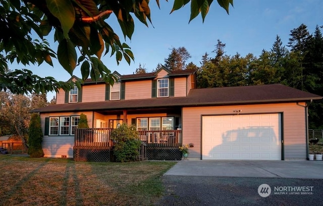 view of front of home featuring a porch and a garage