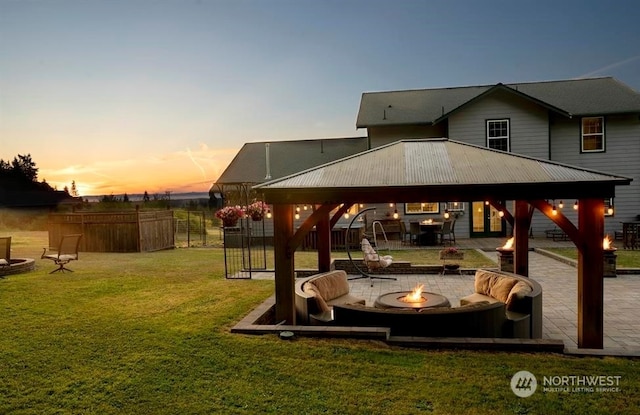 exterior space with a lawn, a patio, a gazebo, and a fire pit