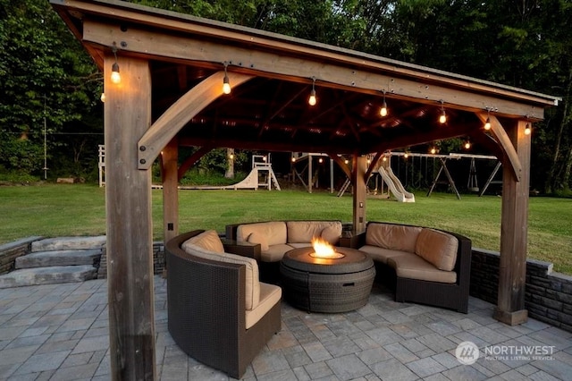 view of patio / terrace with a gazebo, an outdoor living space with a fire pit, and a playground