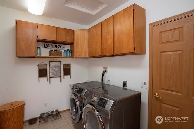 washroom featuring light tile floors, washer and dryer, hookup for a washing machine, hookup for an electric dryer, and cabinets