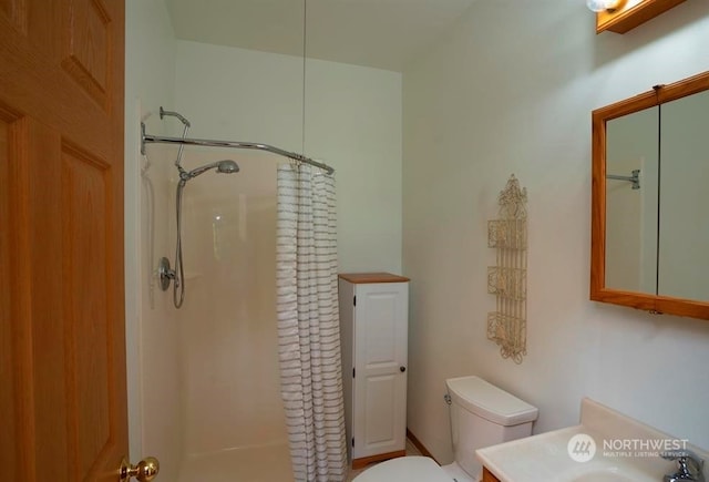 bathroom with a shower with curtain and toilet