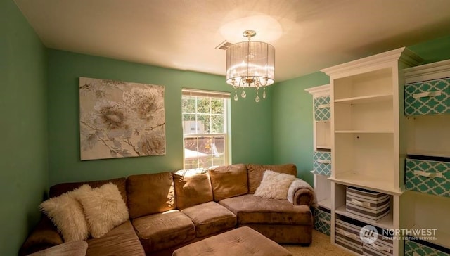 carpeted living room with a chandelier