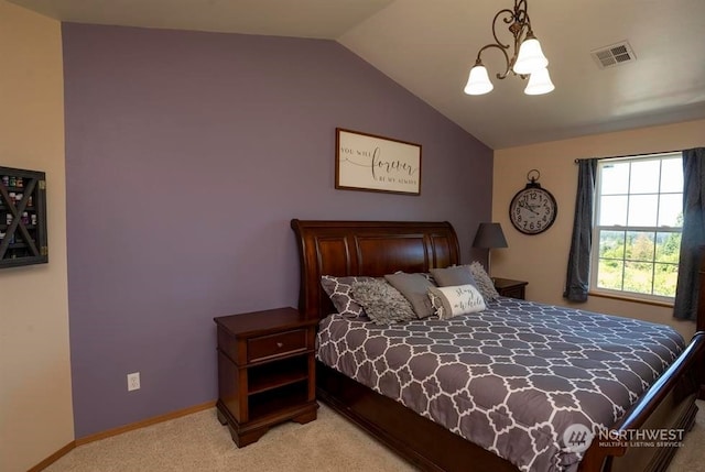 carpeted bedroom featuring a chandelier and vaulted ceiling