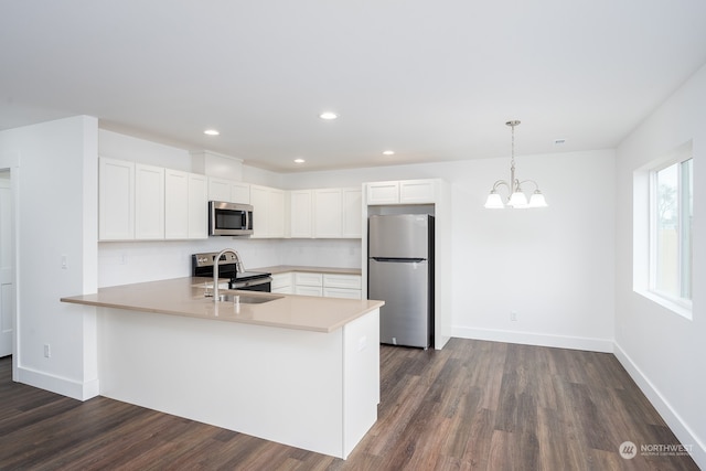 kitchen with an inviting chandelier, dark wood-type flooring, white cabinets, stainless steel appliances, and kitchen peninsula