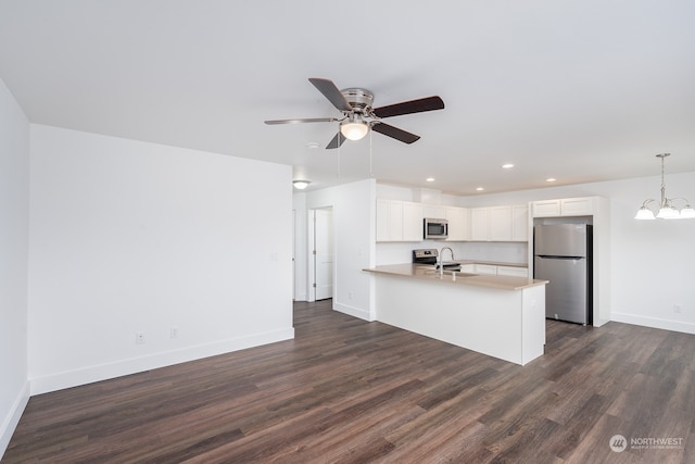 kitchen featuring dark hardwood / wood-style flooring, sink, stainless steel appliances, and white cabinets