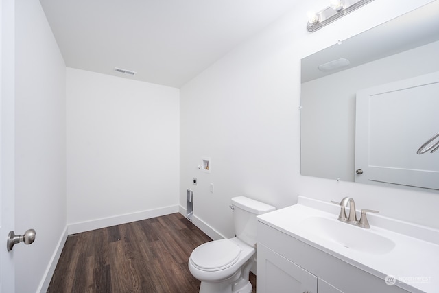 bathroom with vanity, hardwood / wood-style floors, and toilet