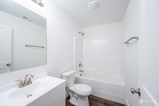 full bathroom with shower / washtub combination, toilet, hardwood / wood-style flooring, and vanity