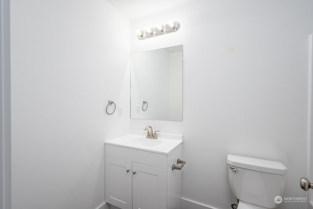 bathroom featuring toilet and vanity