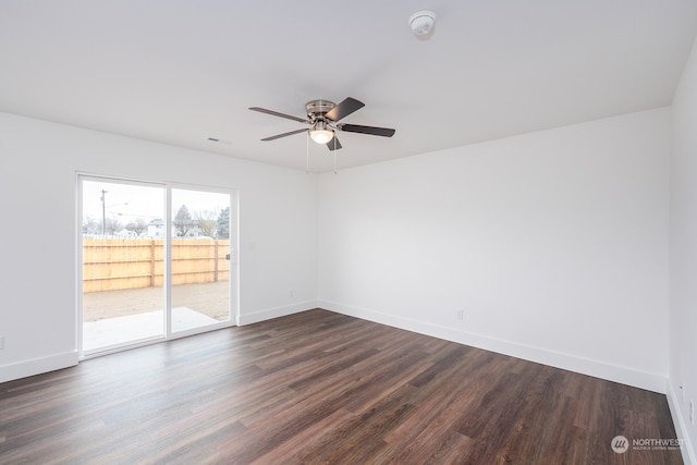 empty room featuring ceiling fan and dark hardwood / wood-style flooring