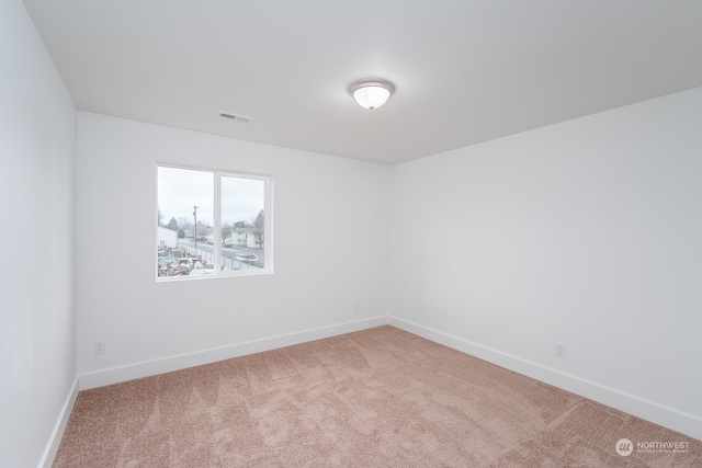 empty room with light colored carpet