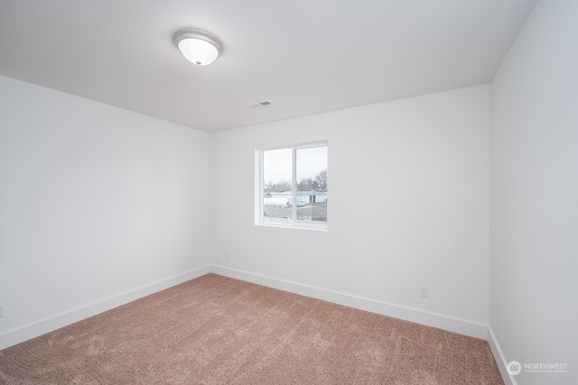 empty room featuring light colored carpet