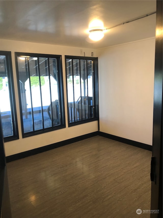 unfurnished room featuring dark hardwood / wood-style floors