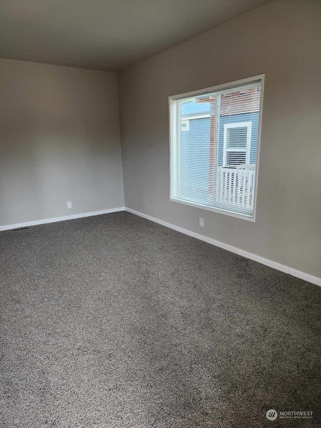 empty room with carpet flooring and baseboards