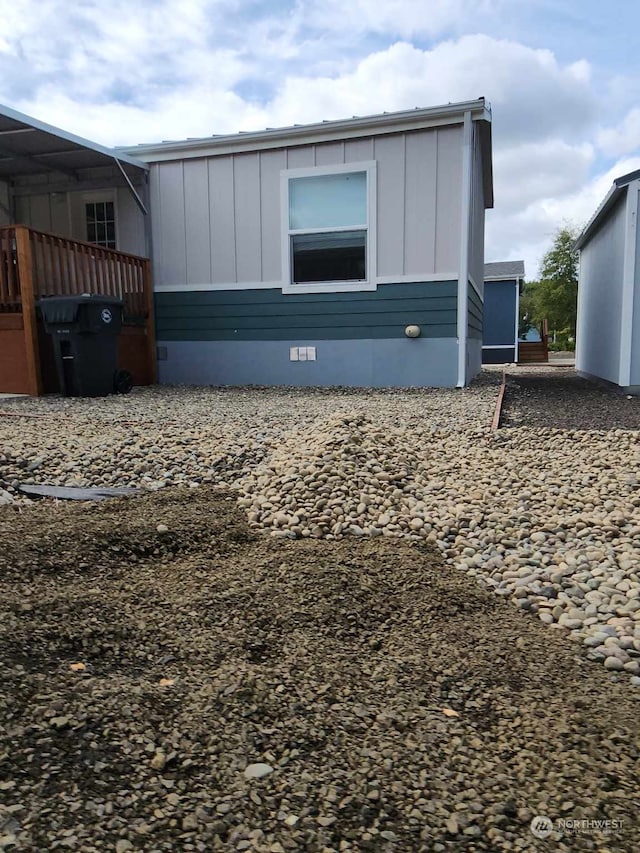 exterior space with crawl space and board and batten siding