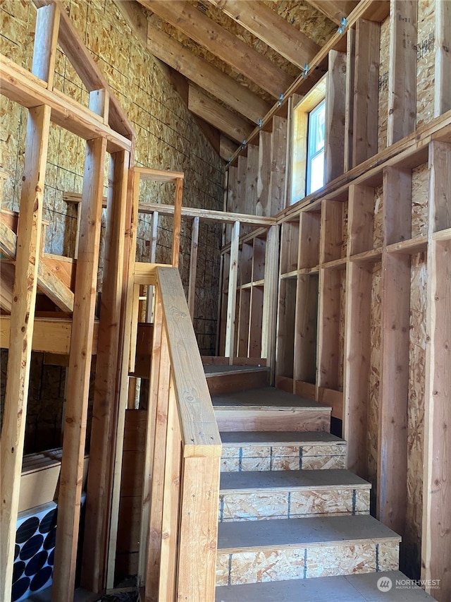 stairway featuring vaulted ceiling