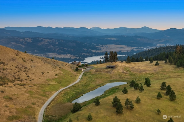 aerial view at dusk with a water and mountain view