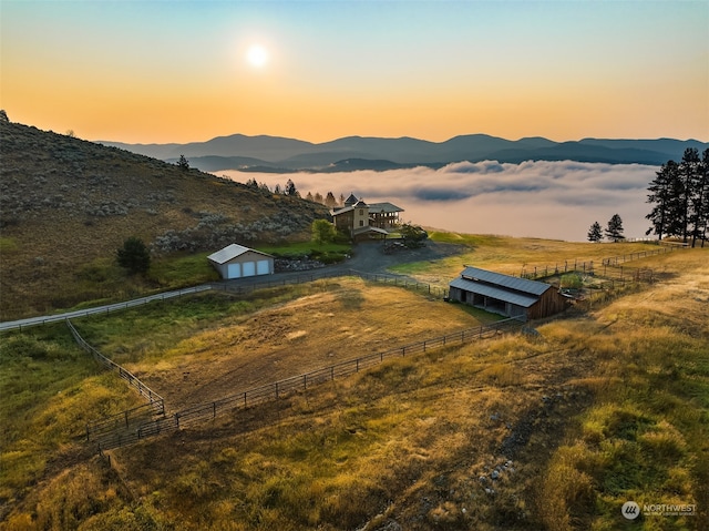 aerial view at dusk with a rural view and a mountain view