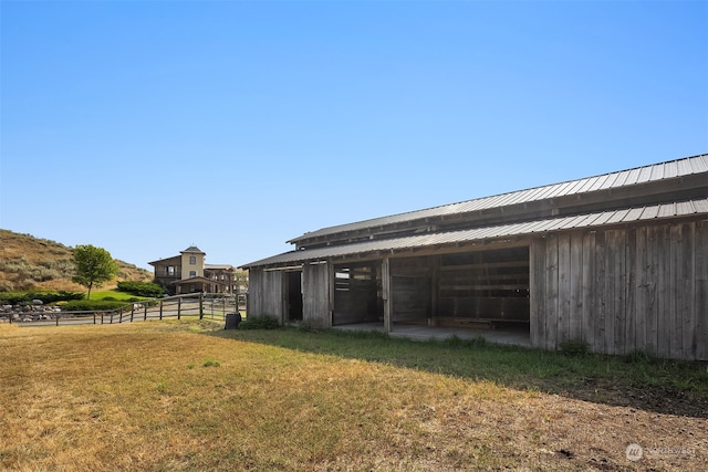 exterior space with an outdoor structure and a lawn