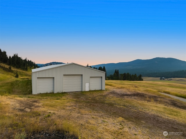 garage at dusk with a mountain view