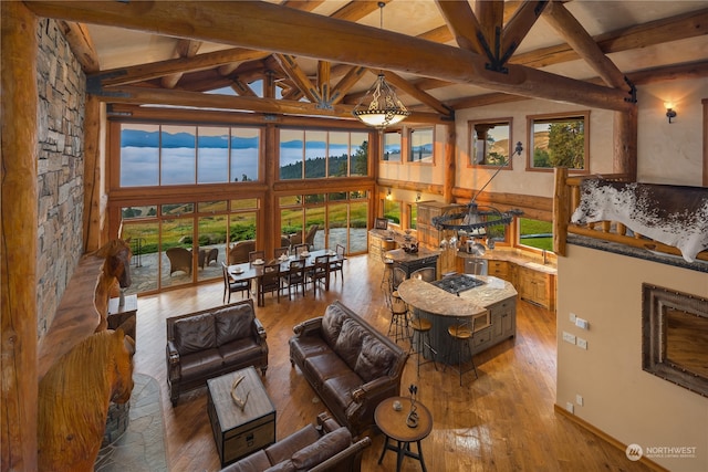 living room featuring beamed ceiling, high vaulted ceiling, and dark wood-type flooring