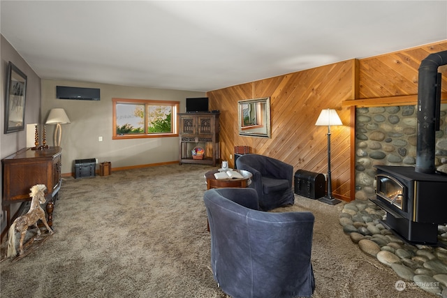 carpeted living room with wooden walls and a wood stove