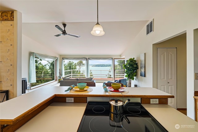 kitchen featuring decorative light fixtures, vaulted ceiling, and ceiling fan