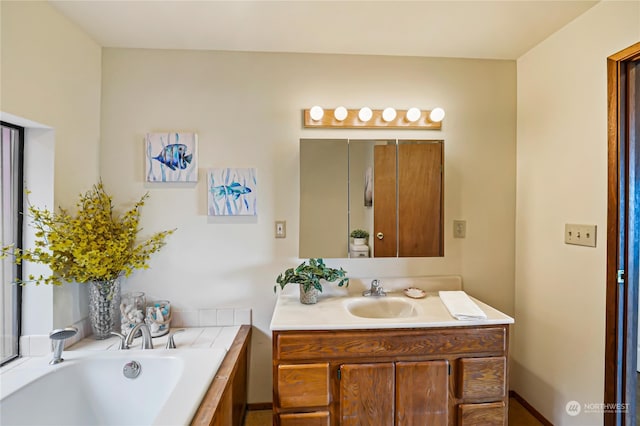 bathroom featuring a tub, vanity, and toilet