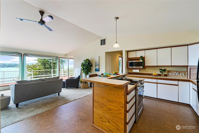 kitchen with ceiling fan, stainless steel appliances, hanging light fixtures, white cabinets, and lofted ceiling