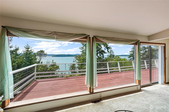 interior space with a water view and carpet