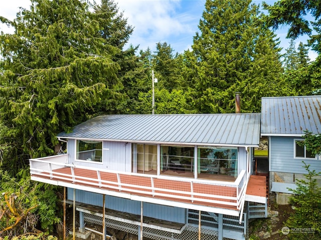 rear view of property featuring a deck