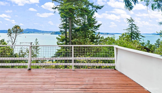 deck with a water and mountain view