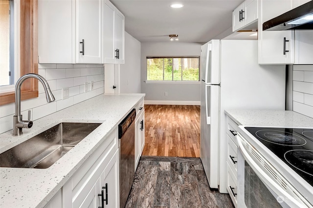 kitchen with dark hardwood / wood-style flooring, backsplash, wall chimney range hood, and white cabinets