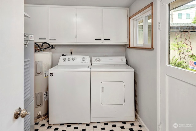 laundry area featuring light tile flooring, electric water heater, separate washer and dryer, and cabinets