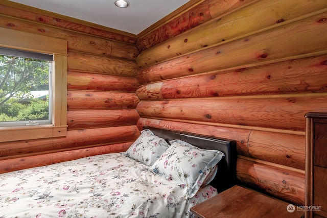 bedroom featuring log walls