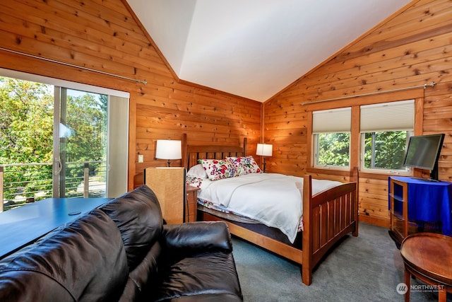 carpeted bedroom featuring wooden walls, vaulted ceiling, and multiple windows