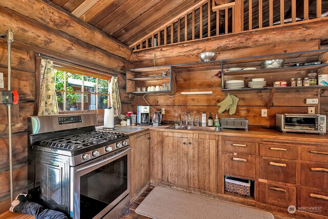 kitchen with vaulted ceiling, wood ceiling, gas stove, and sink