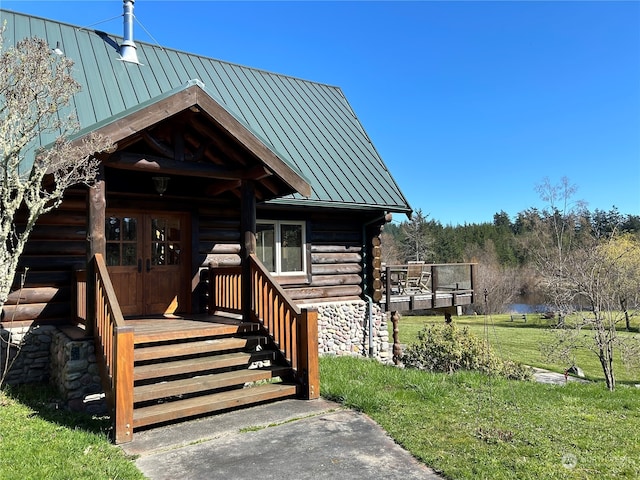 exterior space with a front yard, french doors, and a deck